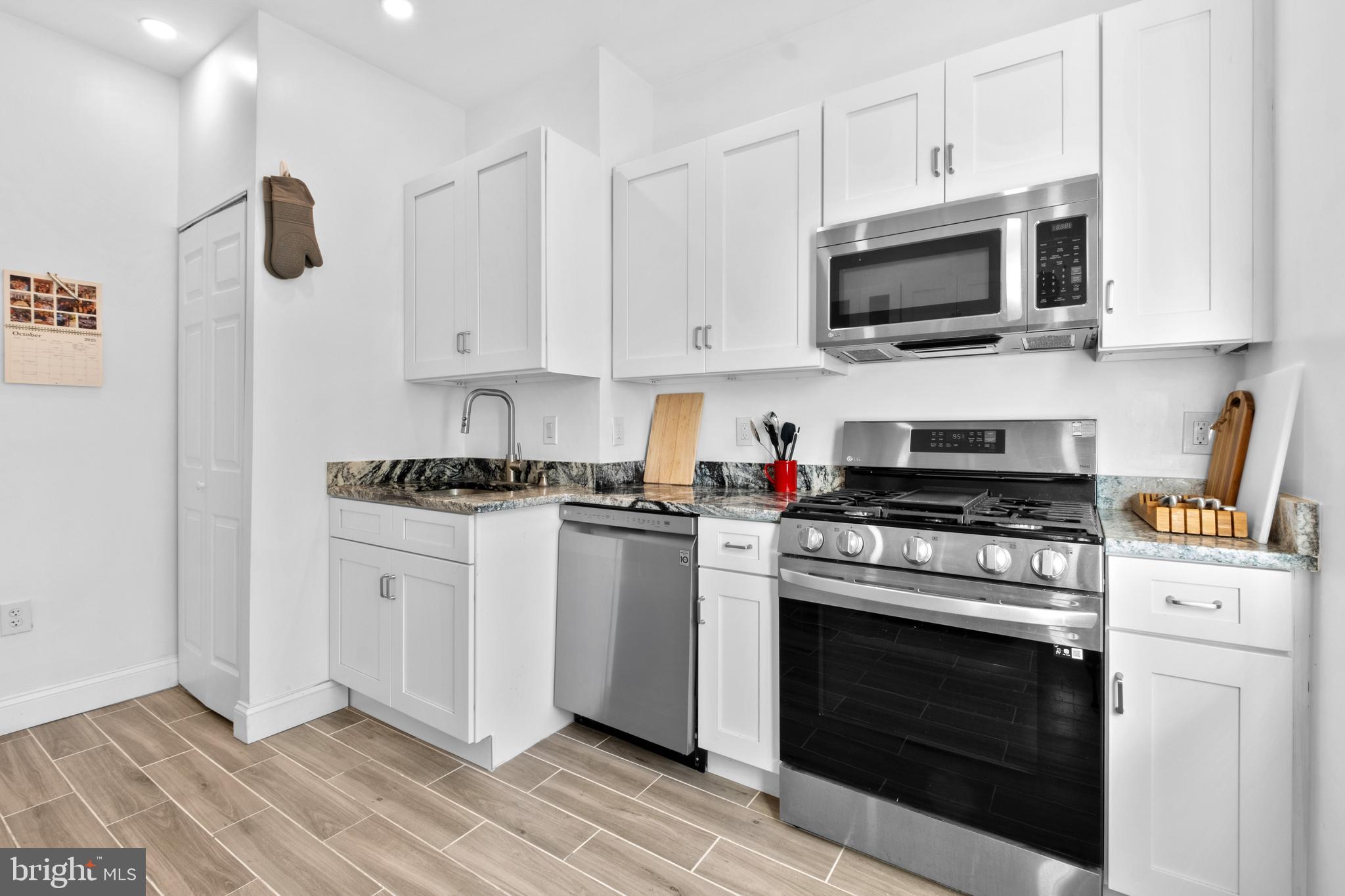 1121 Walnut Street Philadelphia, PA 19107 - Photo 33 of 38 a kitchen with stainless steel appliances white cabinets and a stove a oven with white countertops