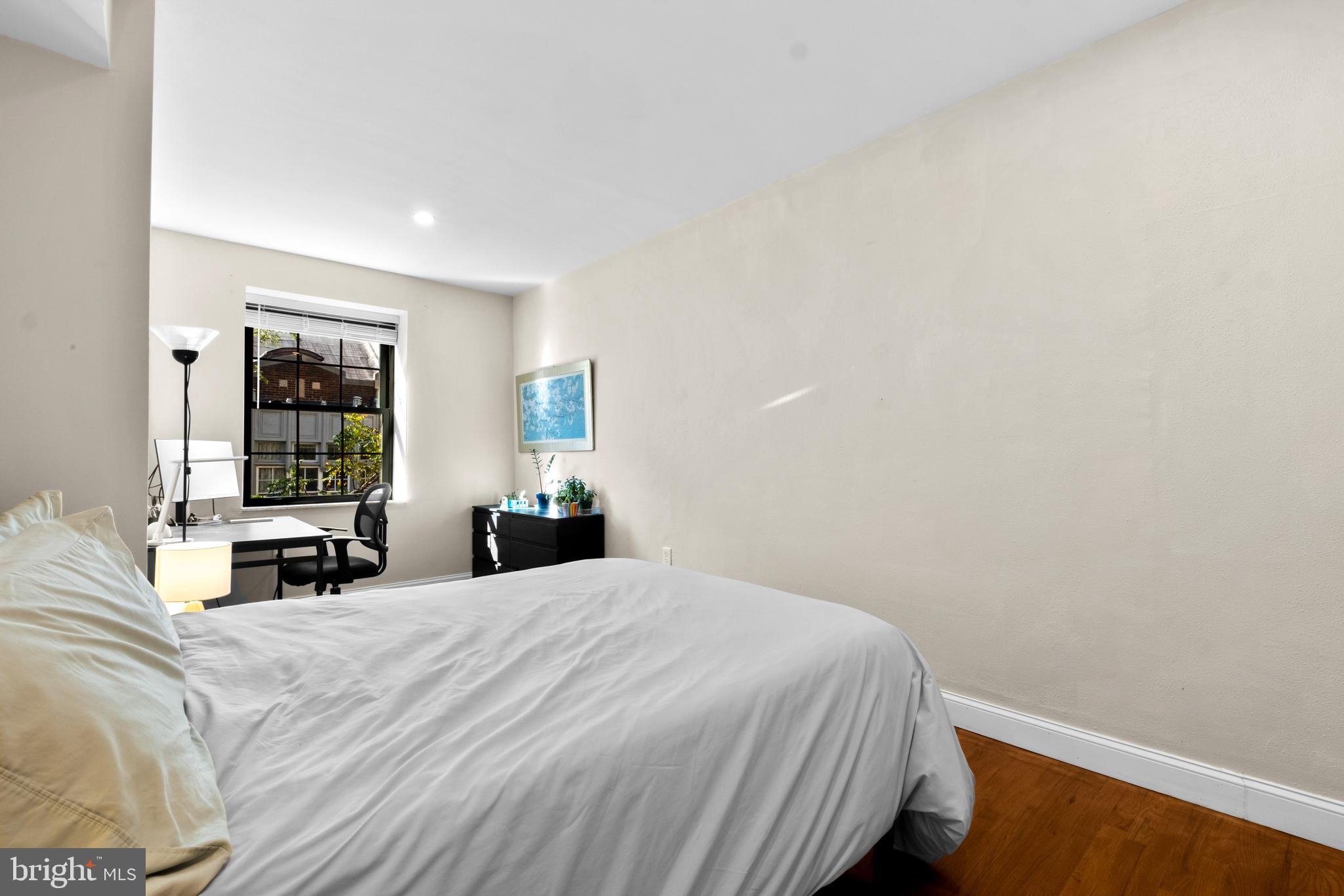 1121 Walnut Street Philadelphia, PA 19107 - Photo 35 of 38 a bedroom with a bed and a large window