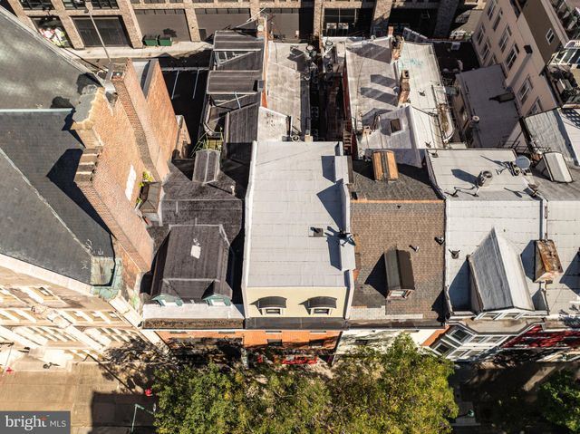 an aerial view of a house with a yard and balcony