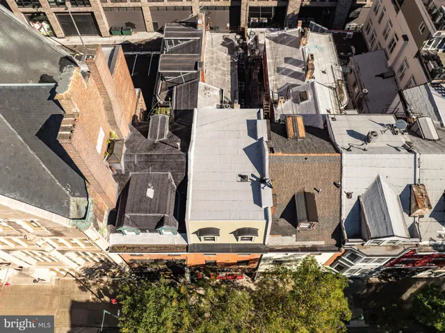 an aerial view of a house with a yard and balcony