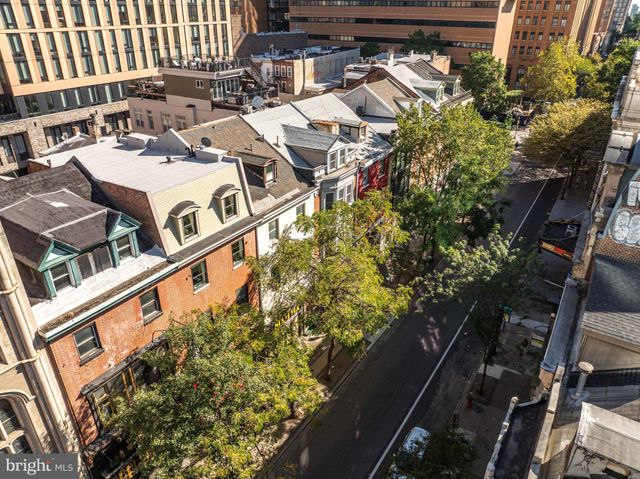 a view of staircase with white walls and a rug