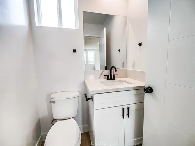 a bathroom with a granite countertop toilet sink and shower