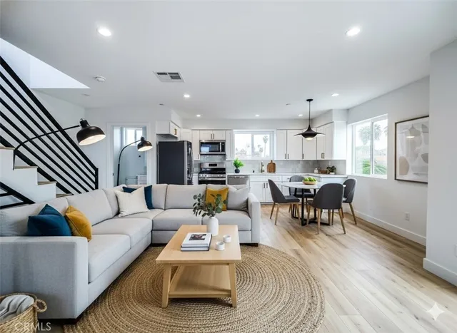a kitchen with stainless steel appliances a refrigerator sink and microwave
