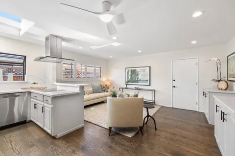 a living room with stainless steel appliances kitchen island granite countertop furniture and a kitchen view