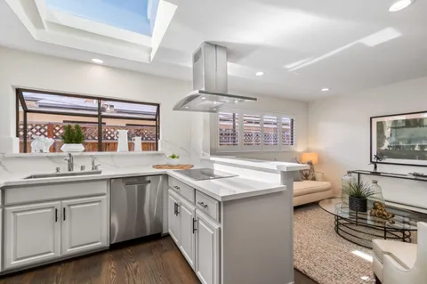 a kitchen with a sink stove and wooden cabinets