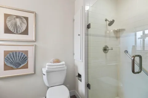 a bathroom with a toilet and a shower