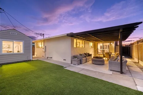 a view of a backyard with sitting area