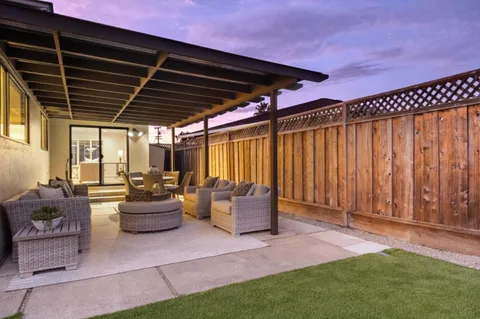 a patio with patio lots of furniture and garden