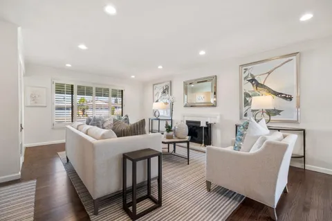 a living room with furniture a fireplace and a table