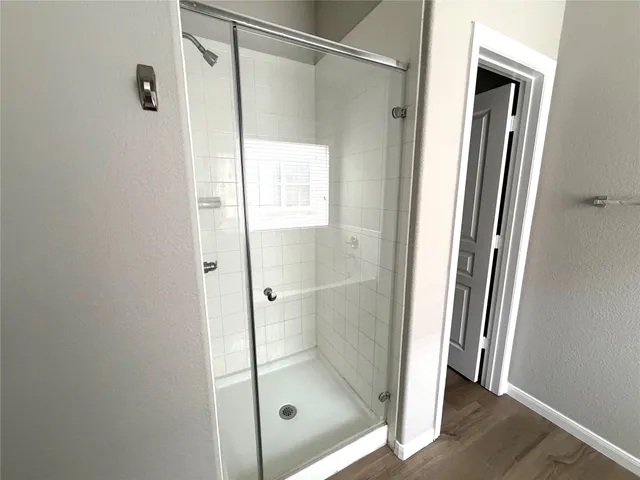 a bathroom with a glass shower door