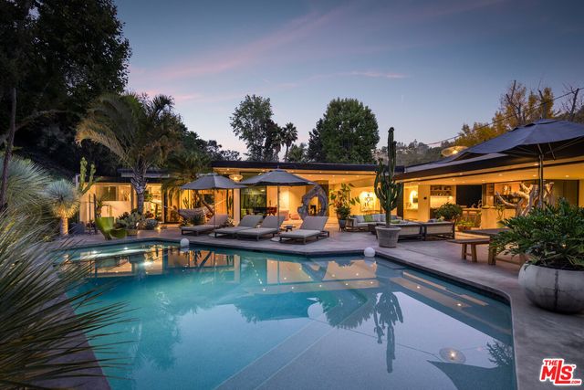 swimming pool view with a seating space