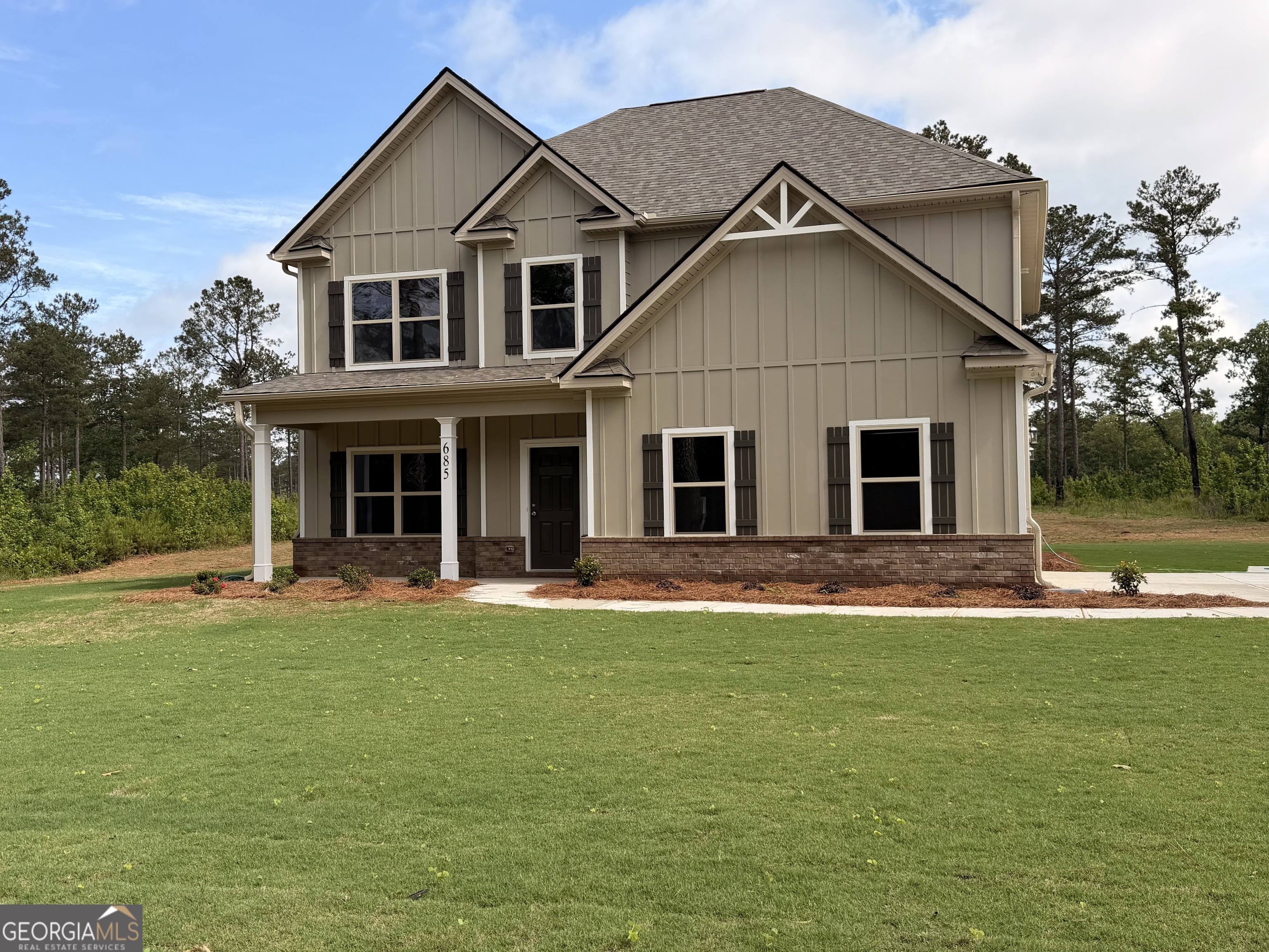 685 Giles Road Forsyth, GA 31029 - Photo 1 of 1 a front view of a house with a garden and yard