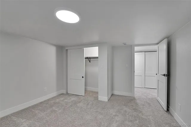 a view of an empty room with a fan