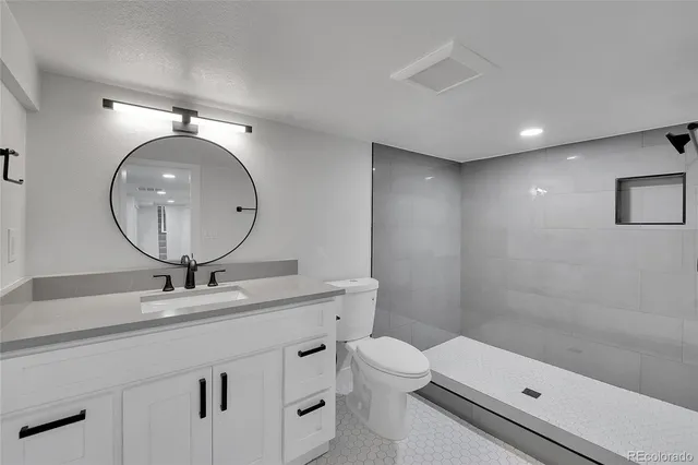 a bathroom with a sink a toilet and a mirror