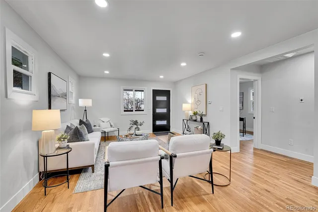 a living room with furniture and wooden floor