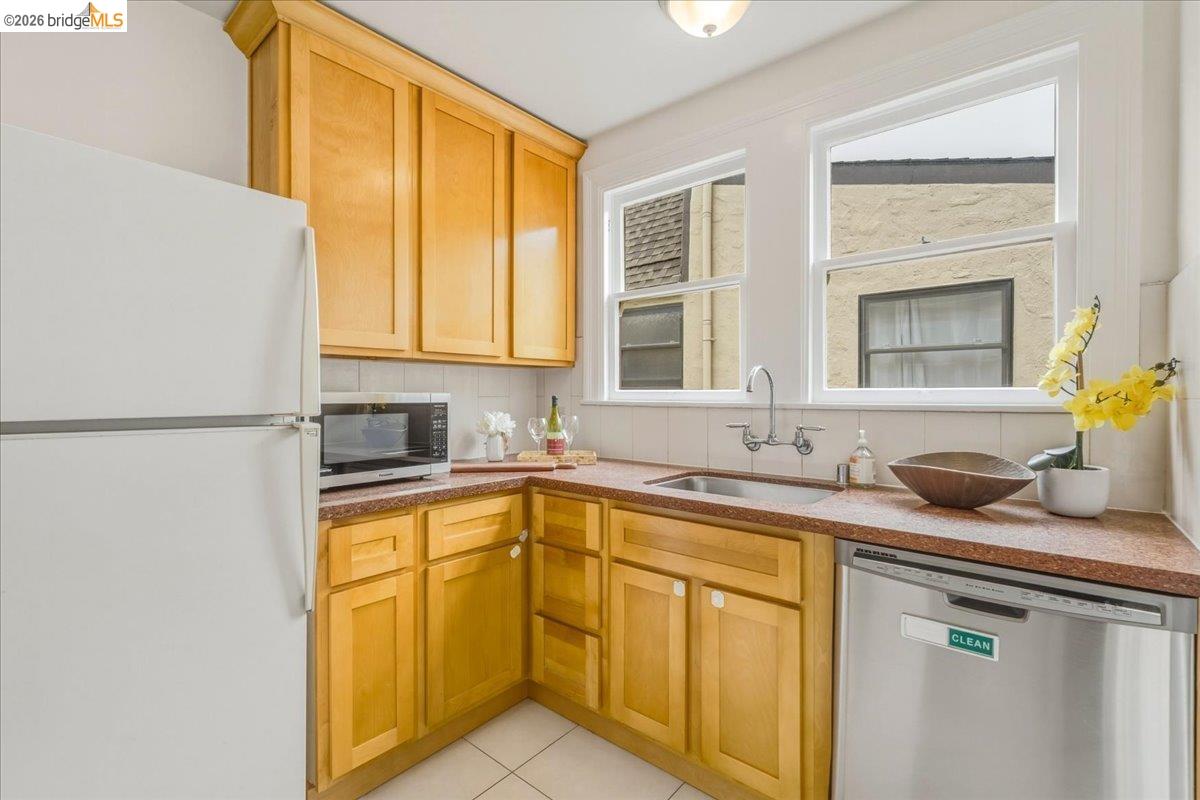 2403 Cedar Street Berkeley, CA 94708 - Photo 11 of 33 Kitchen featuring light wood cabinetry, white appliances, and a stainless steel dishwasher