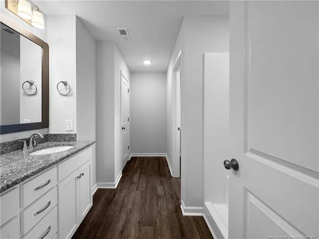 an empty room with a empty space and windows