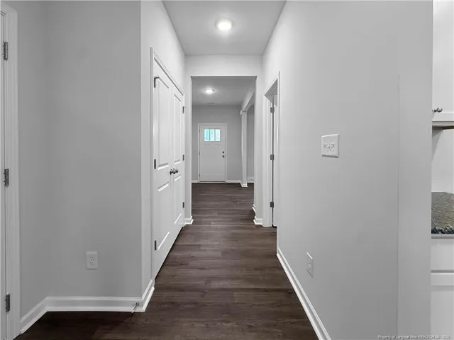 a view of a hallway with wooden floor