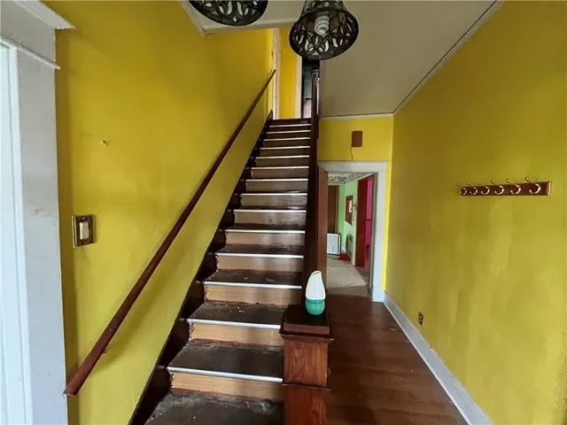 a view of entryway and hall with wooden floor