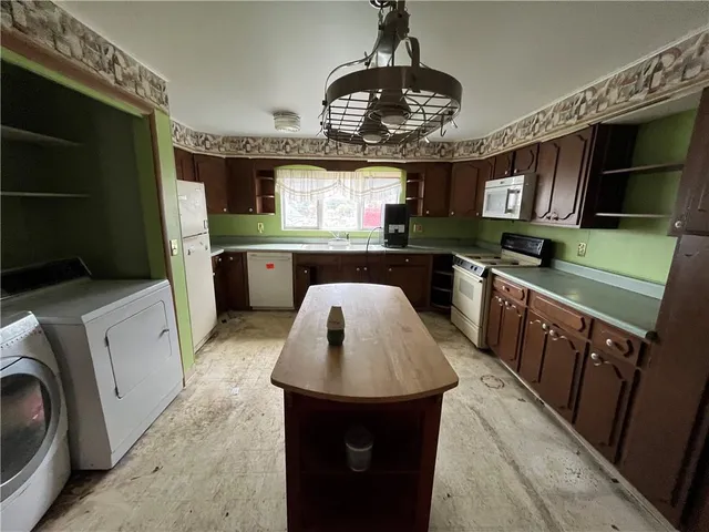 a kitchen with a stove sink and cabinets