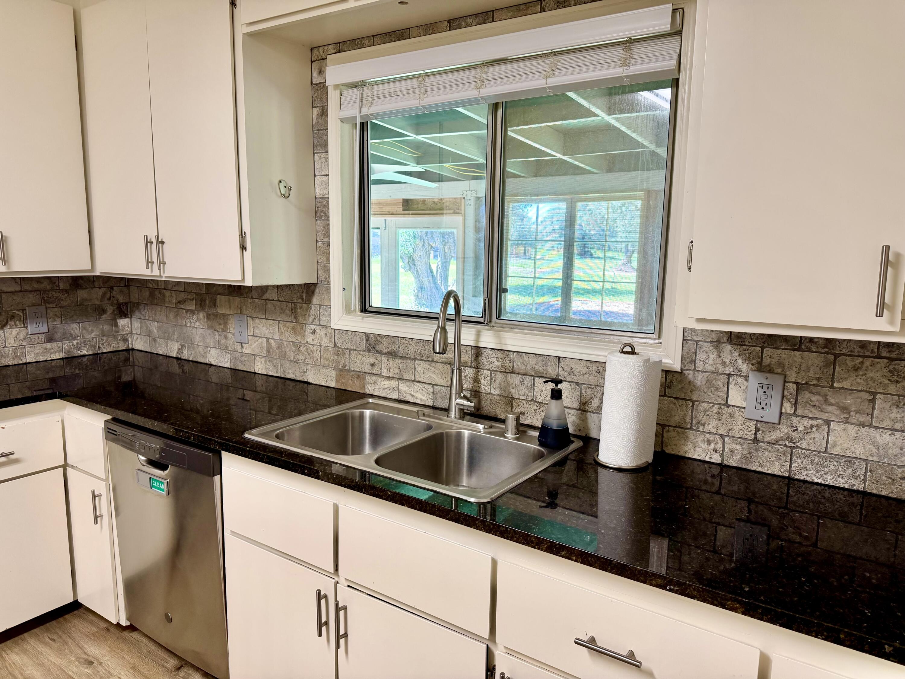 5572 Olive Street Anderson, CA 96007 - Photo 12 of 35 a kitchen with granite countertop a sink and a window