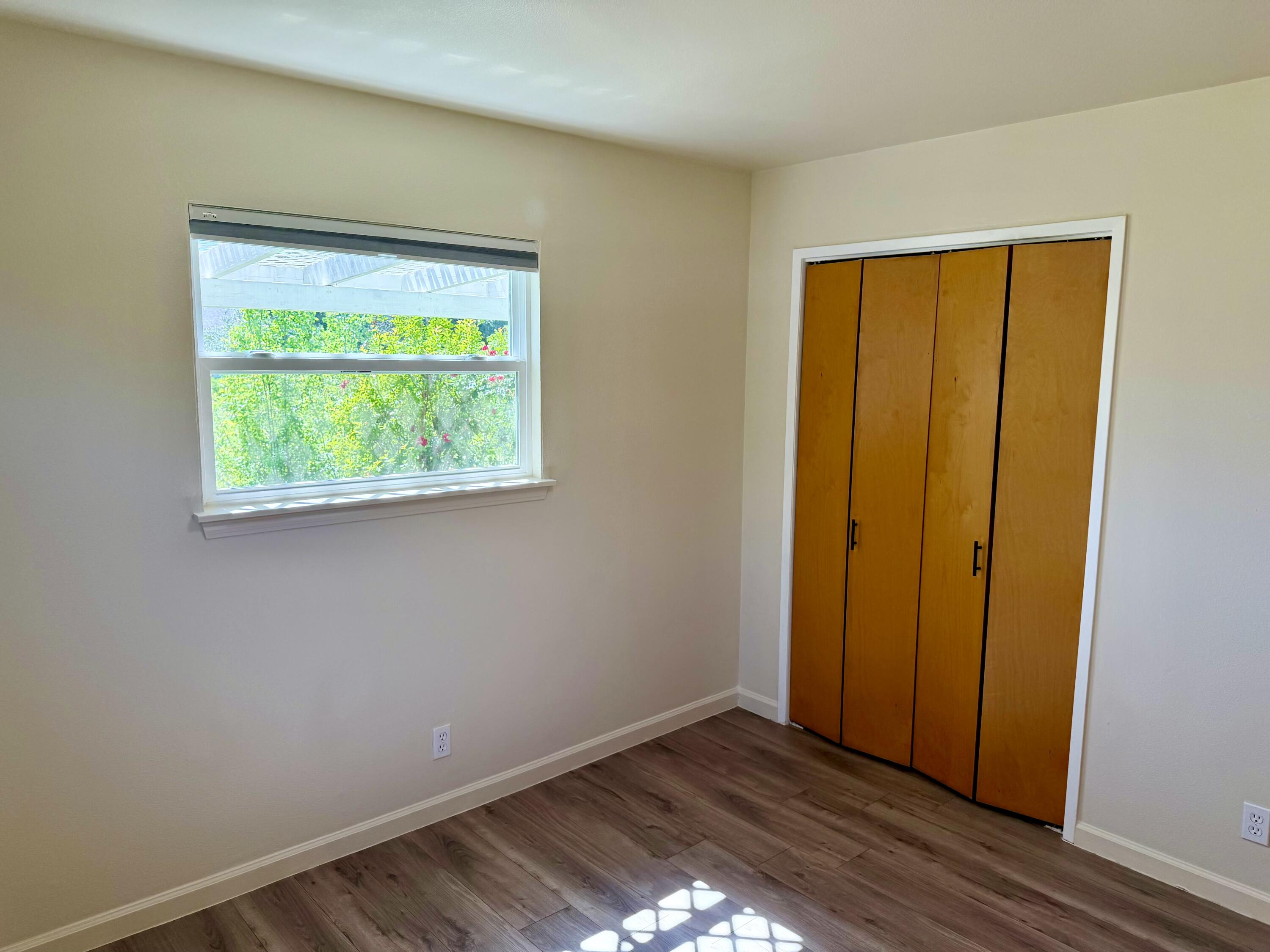 5572 Olive Street Anderson, CA 96007 - Photo 19 of 35 a view of an empty room with wooden floor and a window