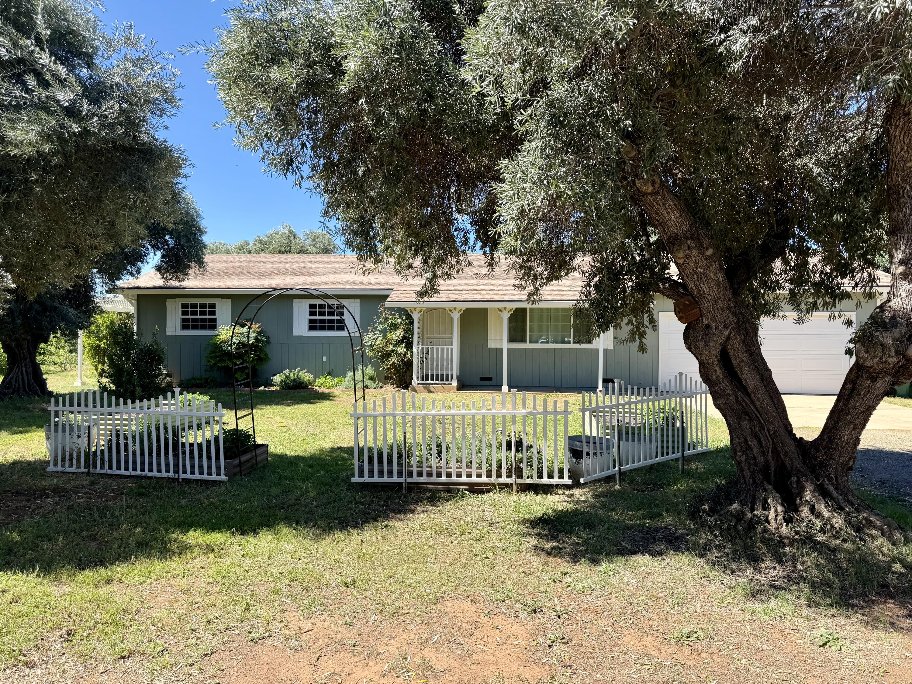 5572 Olive Street Anderson, CA 96007 - Photo 2 of 35 a front view of a house with a garden
