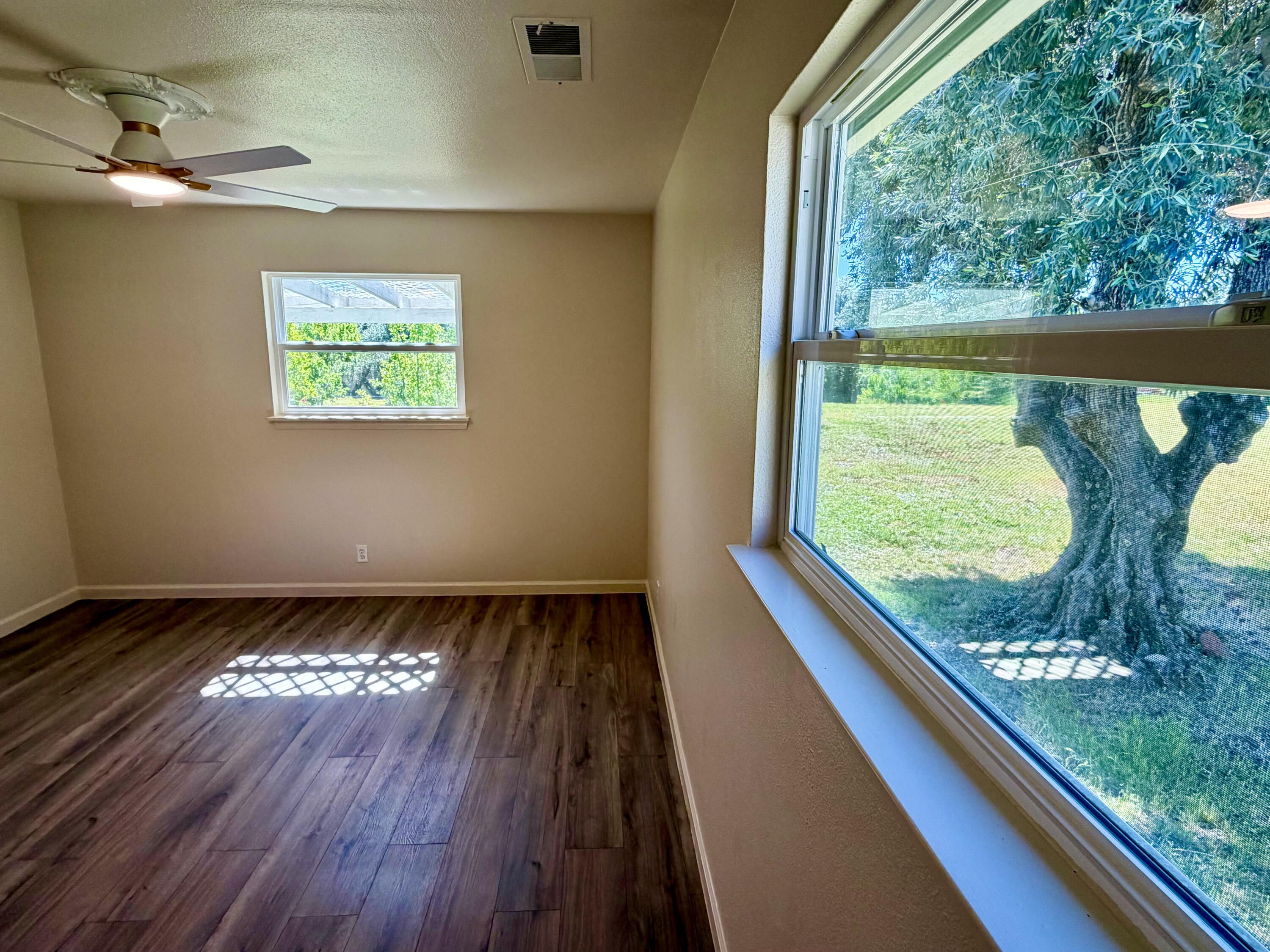 5572 Olive Street Anderson, CA 96007 - Photo 22 of 35 a view of a room with wooden floor and a floor to ceiling window