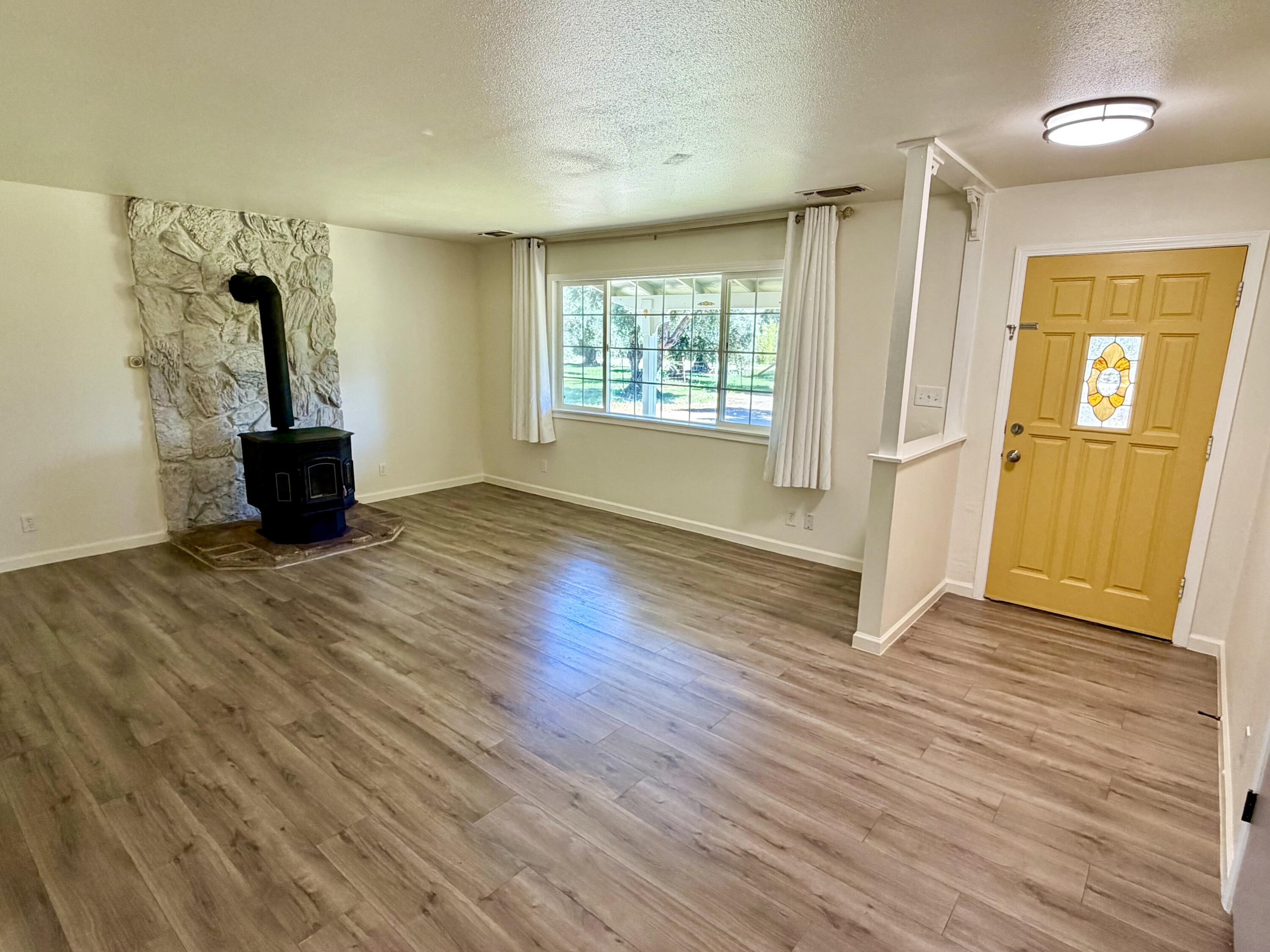 5572 Olive Street Anderson, CA 96007 - Photo 7 of 35 wooden floor in an empty room with a window