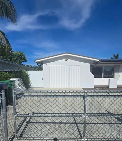 a view of a house with a wooden fence