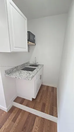 a kitchen with a sink and cabinets