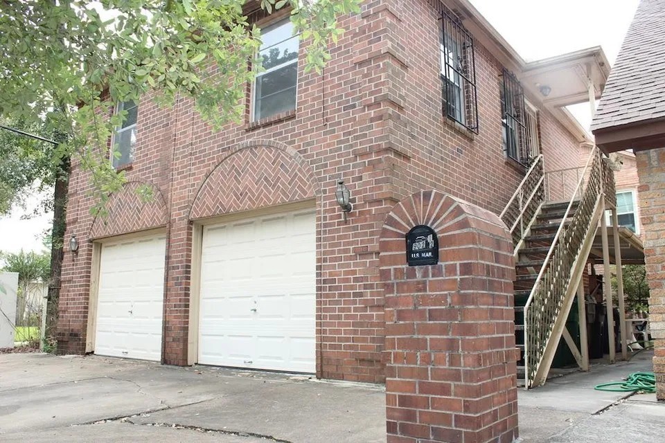 a view of a brick house with a street