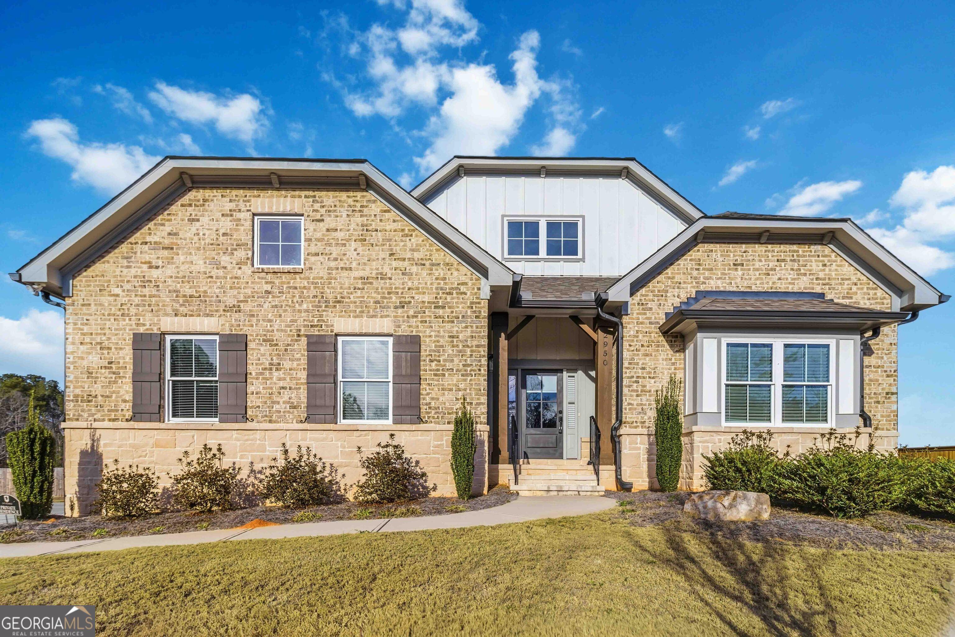 a view of a brick house with large windows