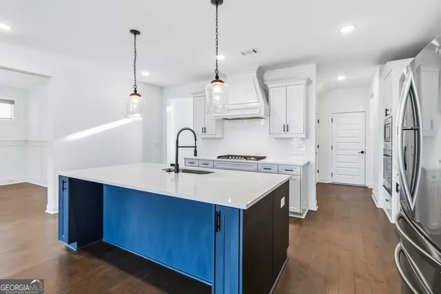 a kitchen with stainless steel appliances a sink stove and refrigerator
