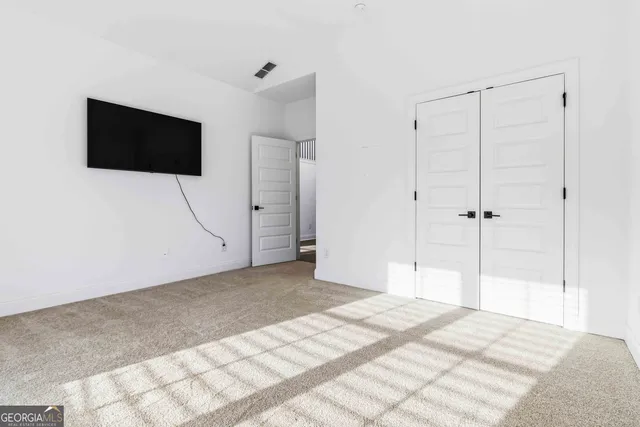 a view of a livingroom with wooden floor and cabinet