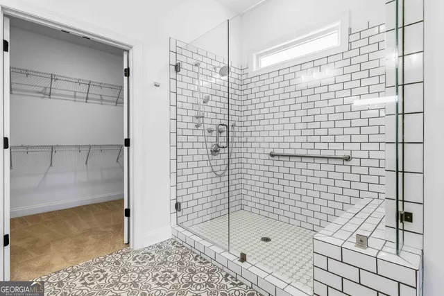 a bathroom with a bathtub and shower