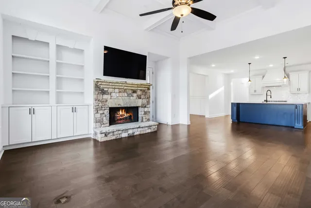 a view of empty room with wooden floor and fireplace