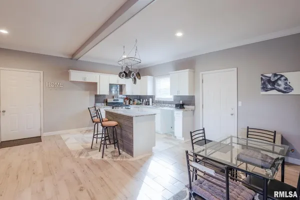 a kitchen with a table chairs and a kitchen view