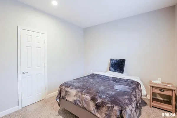 a bedroom with a bed and a tv