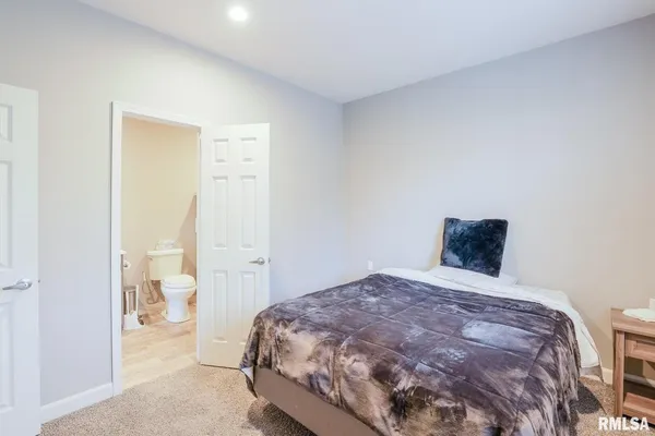 a bedroom with a bed and walk in closet