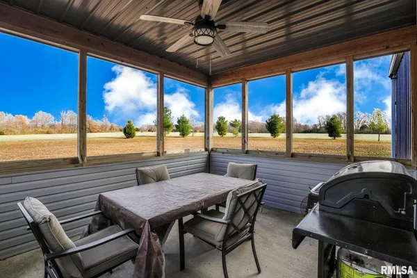 a view of a patio with a table and chairs