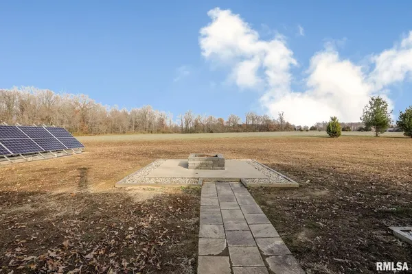 a view of a dry yard with wooden fence