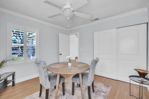 a view of a dining room with furniture window and wooden floor