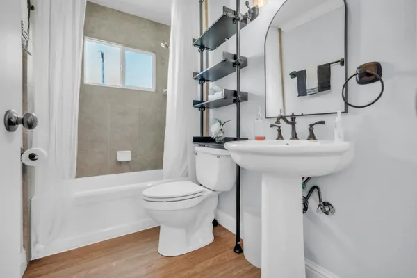 a bathroom with a sink toilet and shower