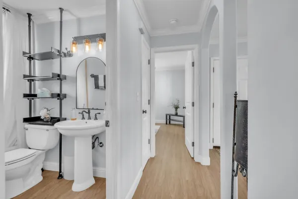 a bathroom with a sink a toilet and shower