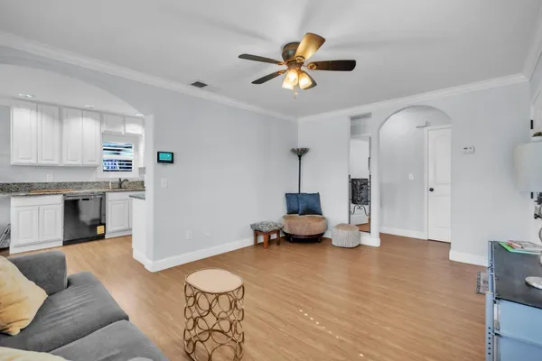 a living room with furniture and kitchen view