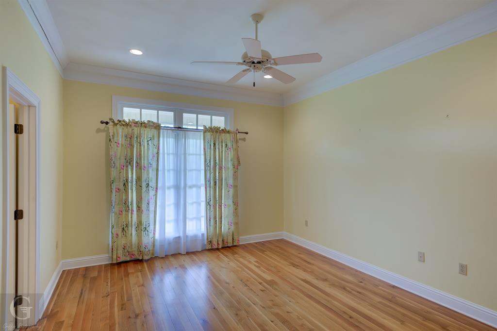 1212 WPA Road Homer, LA 71040 - Photo 13 of 35 Spare room with crown molding, wood finished floors, baseboards, a ceiling fan, and recessed lighting