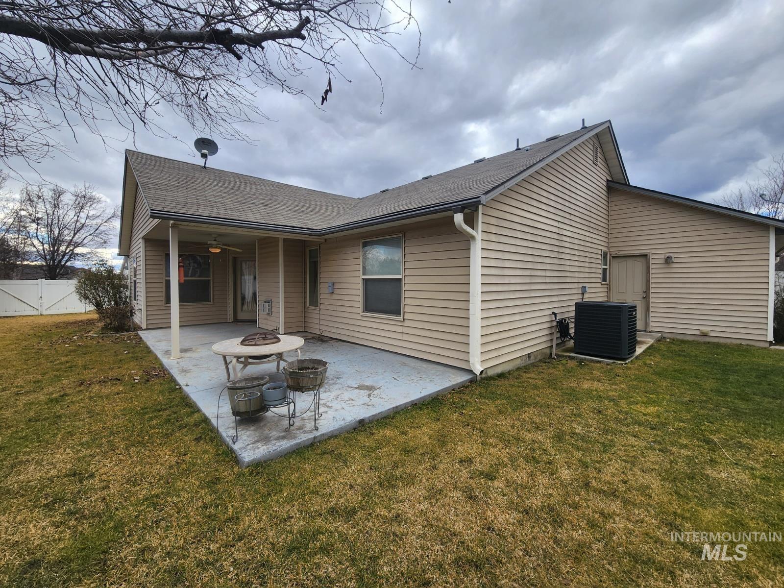 1000 North Rodeo Street Parma, ID 83660 - Photo 31 of 35 Back of property with a patio area, a shingled roof, an outdoor fire pit, and a ceiling fan