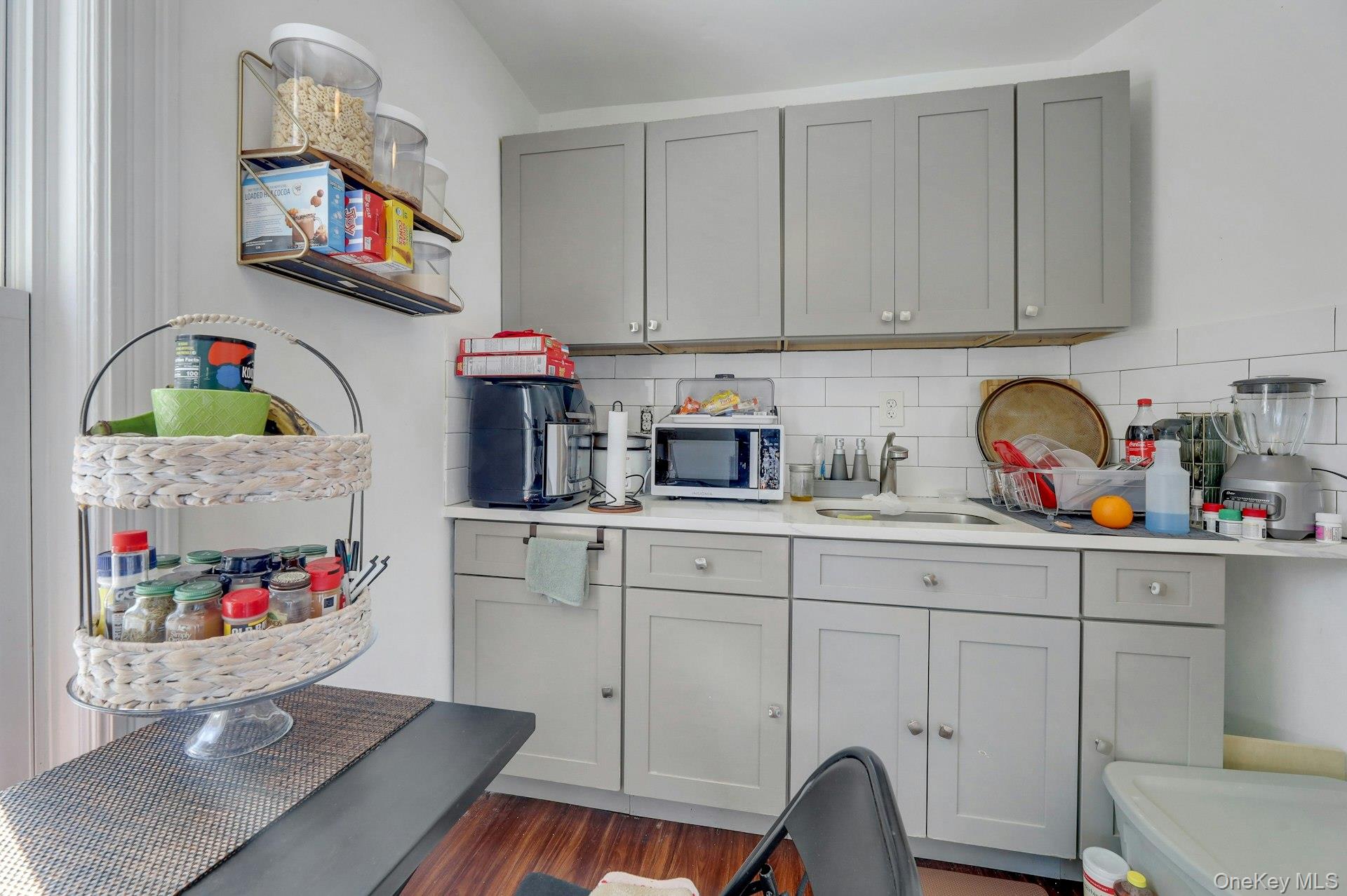 65 Lake Road Valley Cottage, NY 10989 - Photo 27 of 33 a kitchen with white cabinets and sink