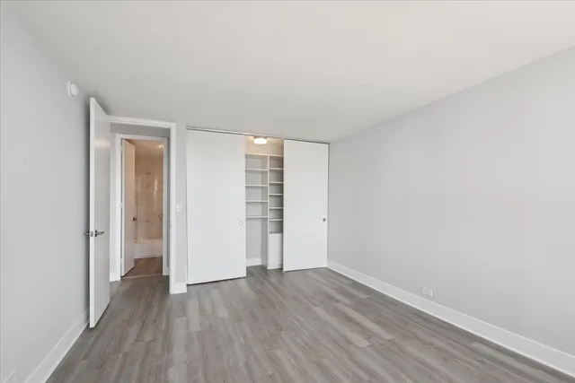 a bathroom with a granite countertop toilet and a shower